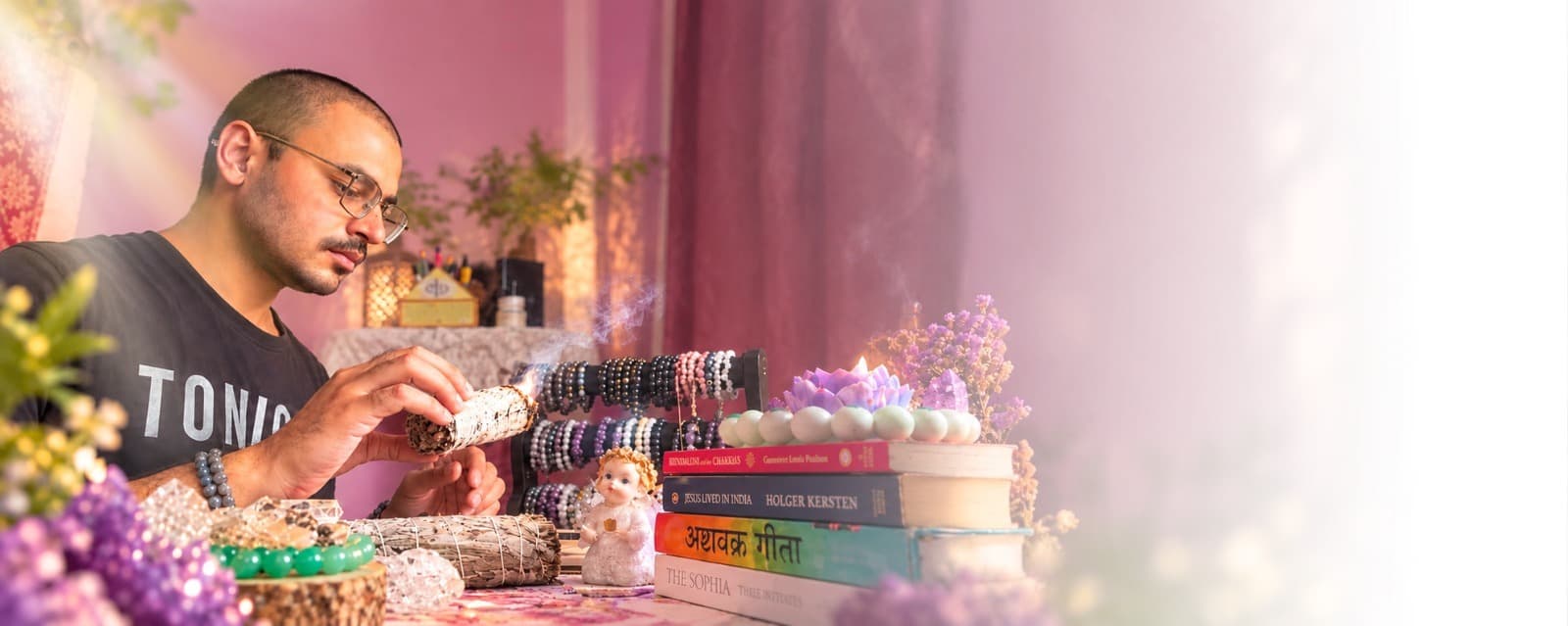 Ritesh Rai, founder of Kryistal Shop, sitting with healing crystals